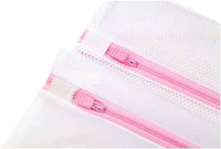 Mesh laundry bags different sizes laid out flat