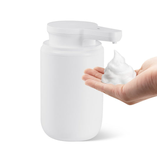 Touchless automatic soap dispenser dispensing foam onto a hand