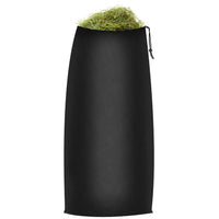 Black drawstring hay bag filled with fresh green hay for horse feeding