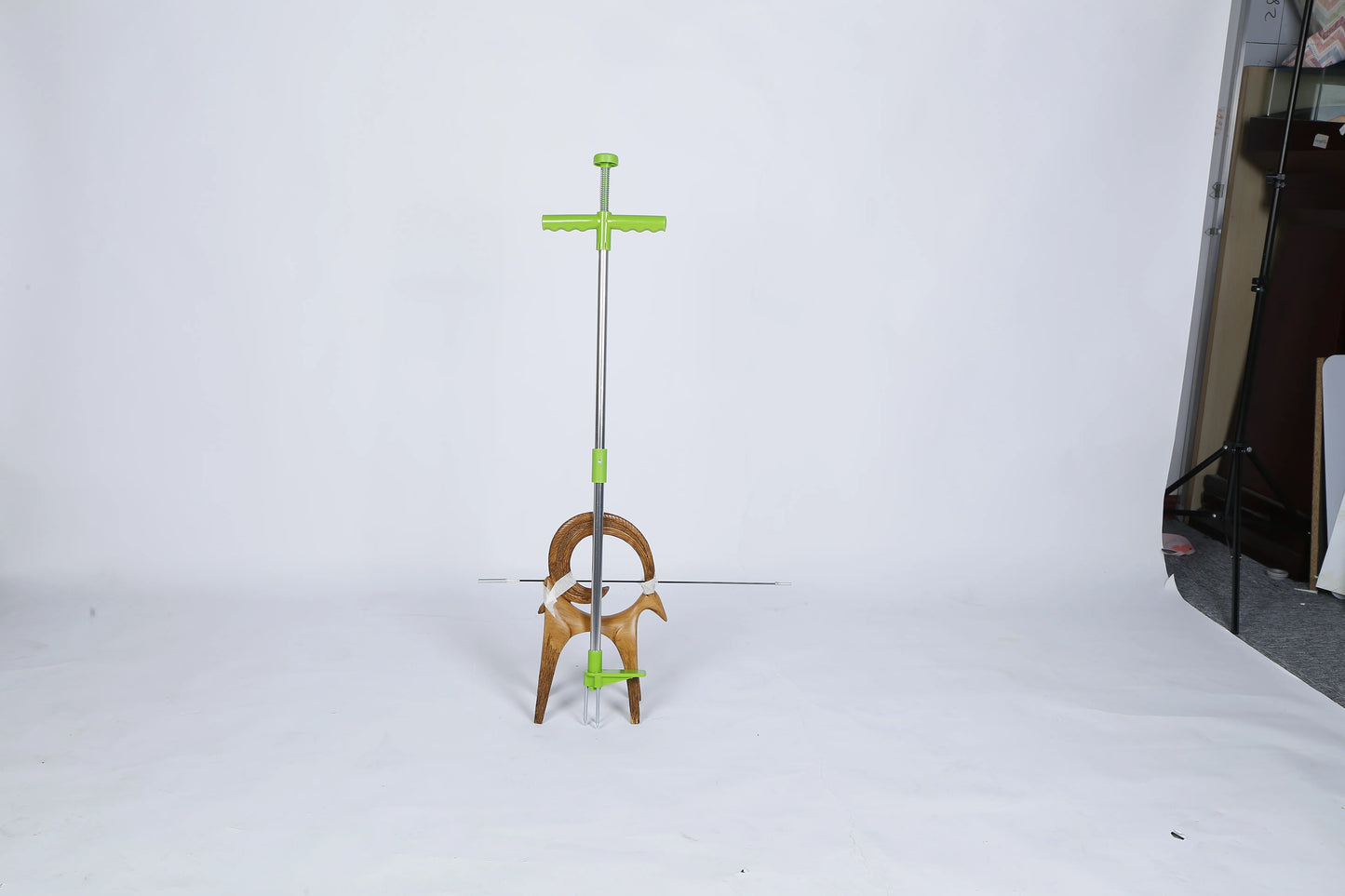 Person using stand-up weed puller outdoors