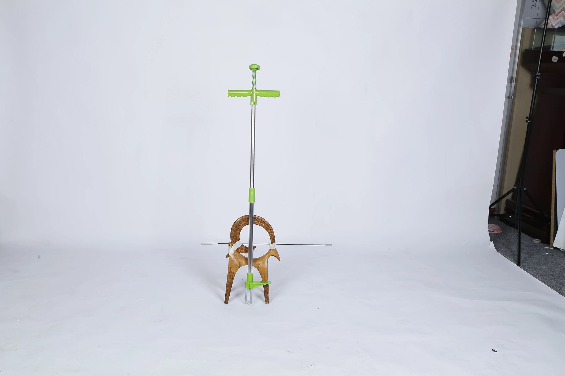 Person using stand-up weed puller outdoors