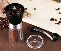 Hand-crank coffee grinder mechanism close-up with ceramic burr dial