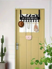 Door hook organizer mounted with coats and bags hanging