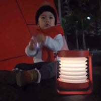 LED lantern lamp expanded and glowing on nightstand